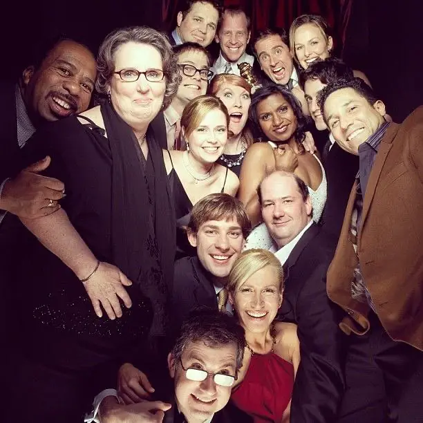 Actors and actresses from The Office posing for a photo. 