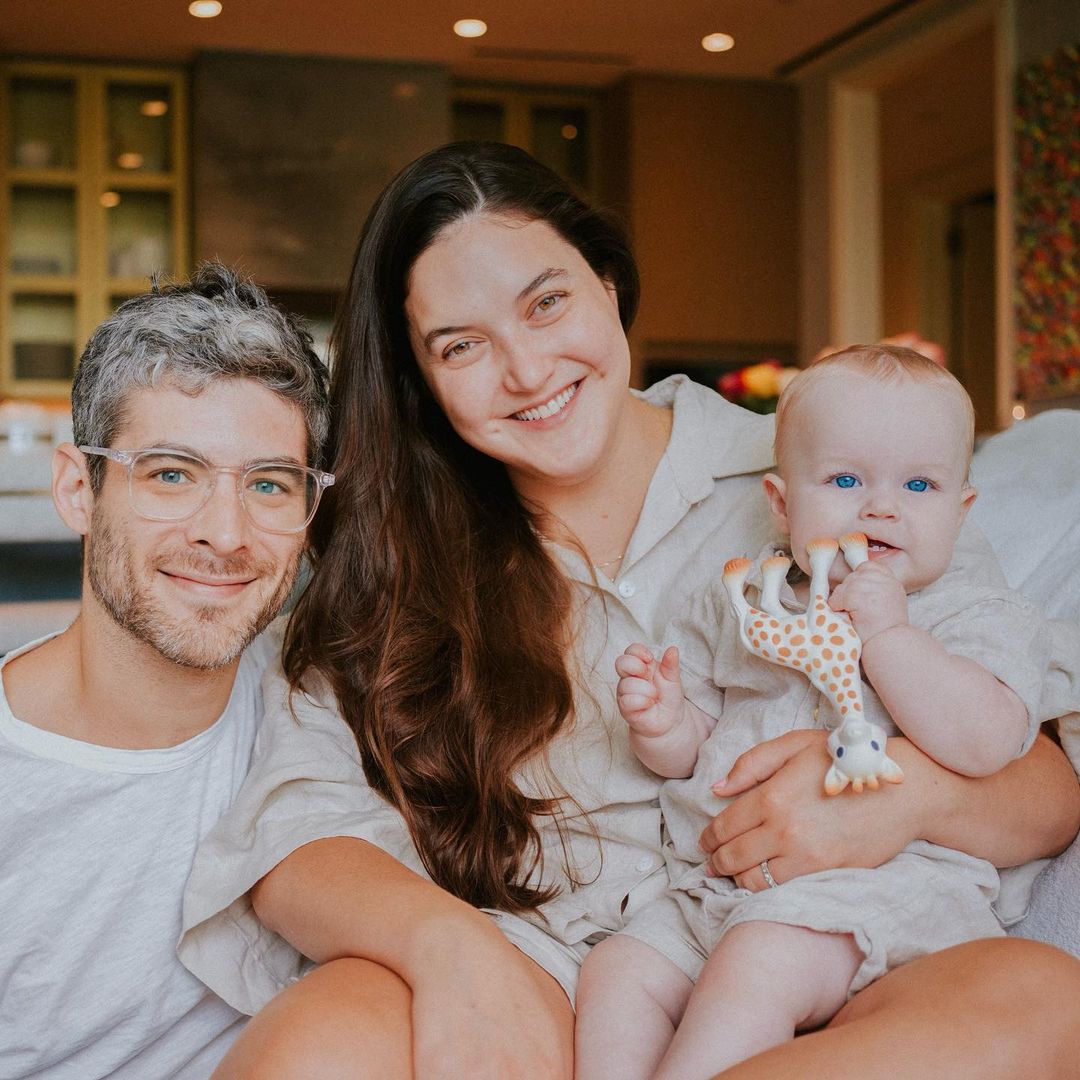 Alaia Aronow posing for a picture with her husband, Andrew Aronow, and daughter Iris.