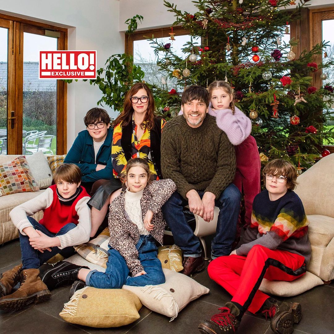 The bassist with his spouse and children posing for a picture