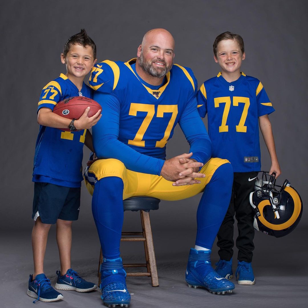 Andrew Whitworth posing with his sons, Drew and Michael.
