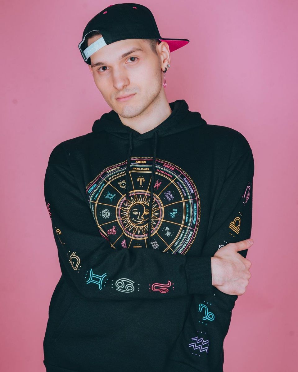 Antphrodite wearing an astrology-themed hoodie.