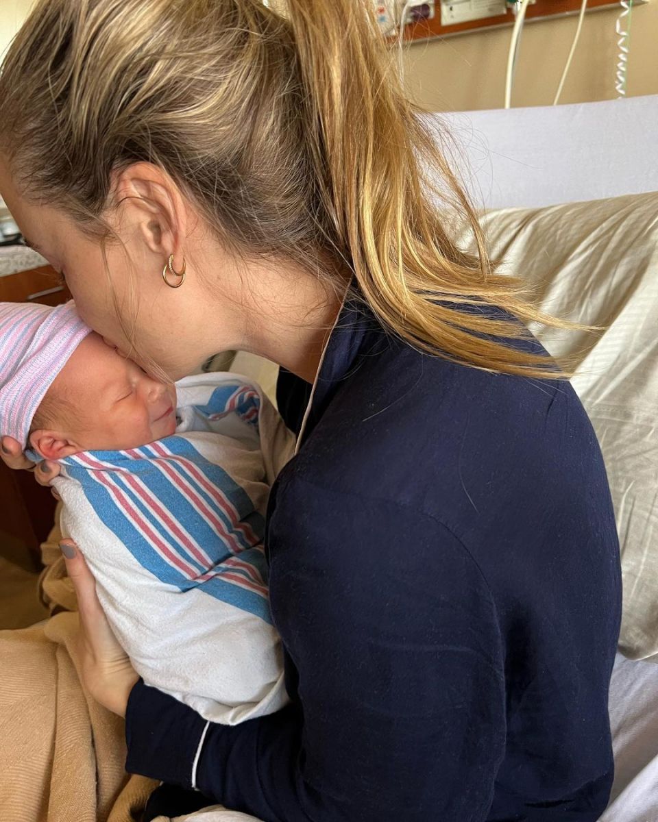 Becca Tobin holds her first baby with her husband Zach Martin.