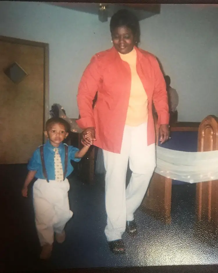 A young DeVonta Smith with one of his parents, mom.Christine Smith-Sylve.