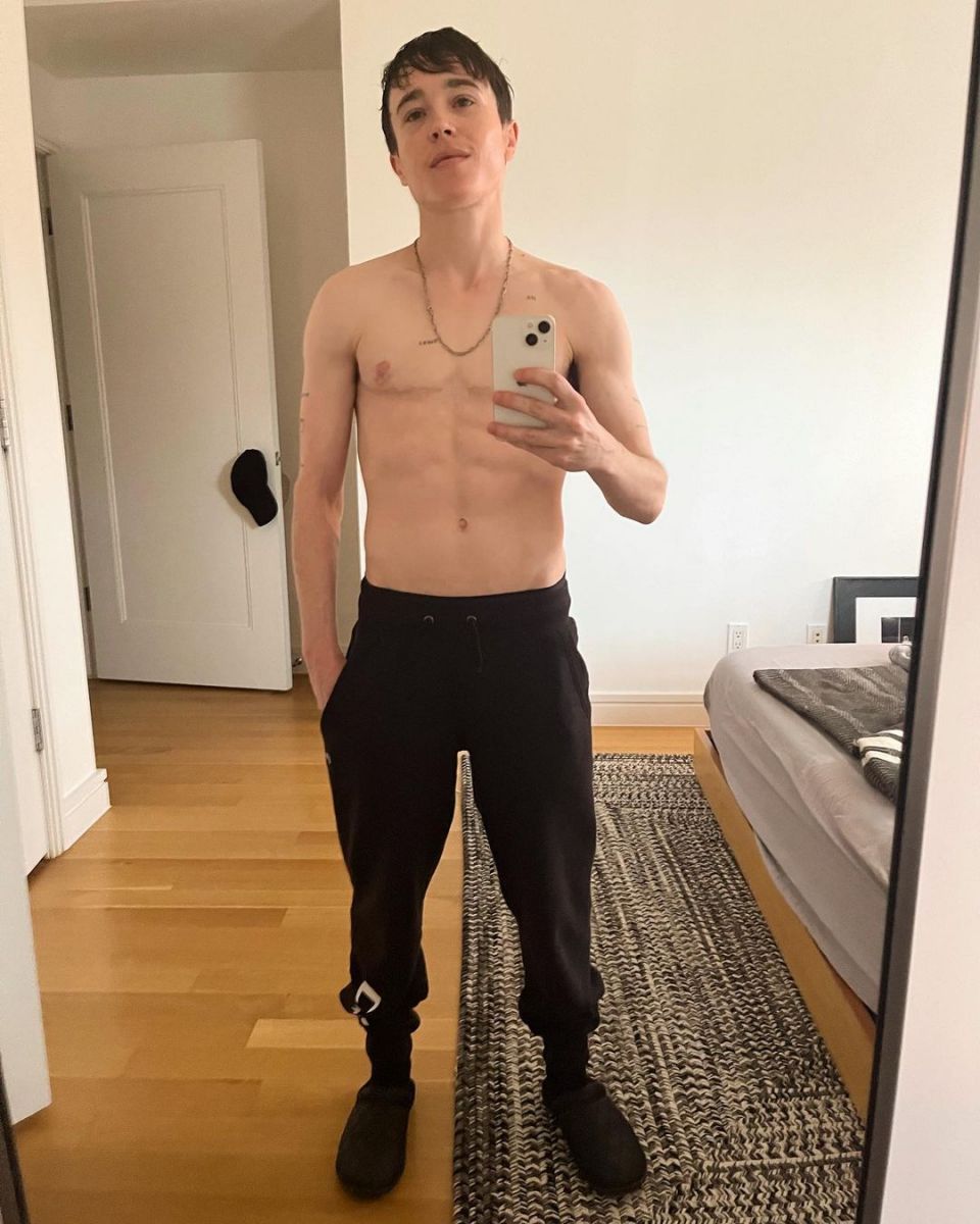 Elliot Page showing off his abs while taking a mirror selfie.