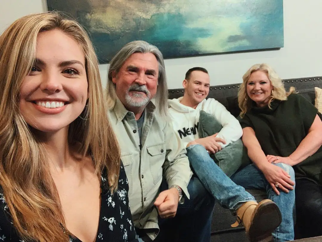 Hannah Brown takes a selfie with her parents and brother.