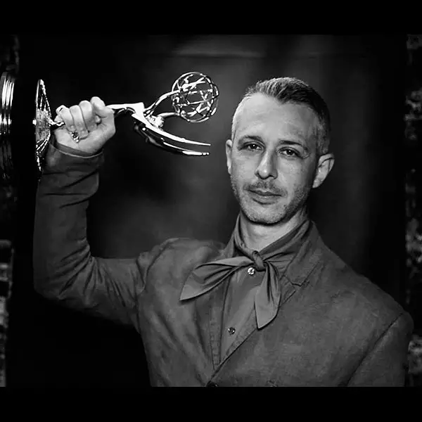 Jeremy Strong posing for a picture, showing off his Emmy