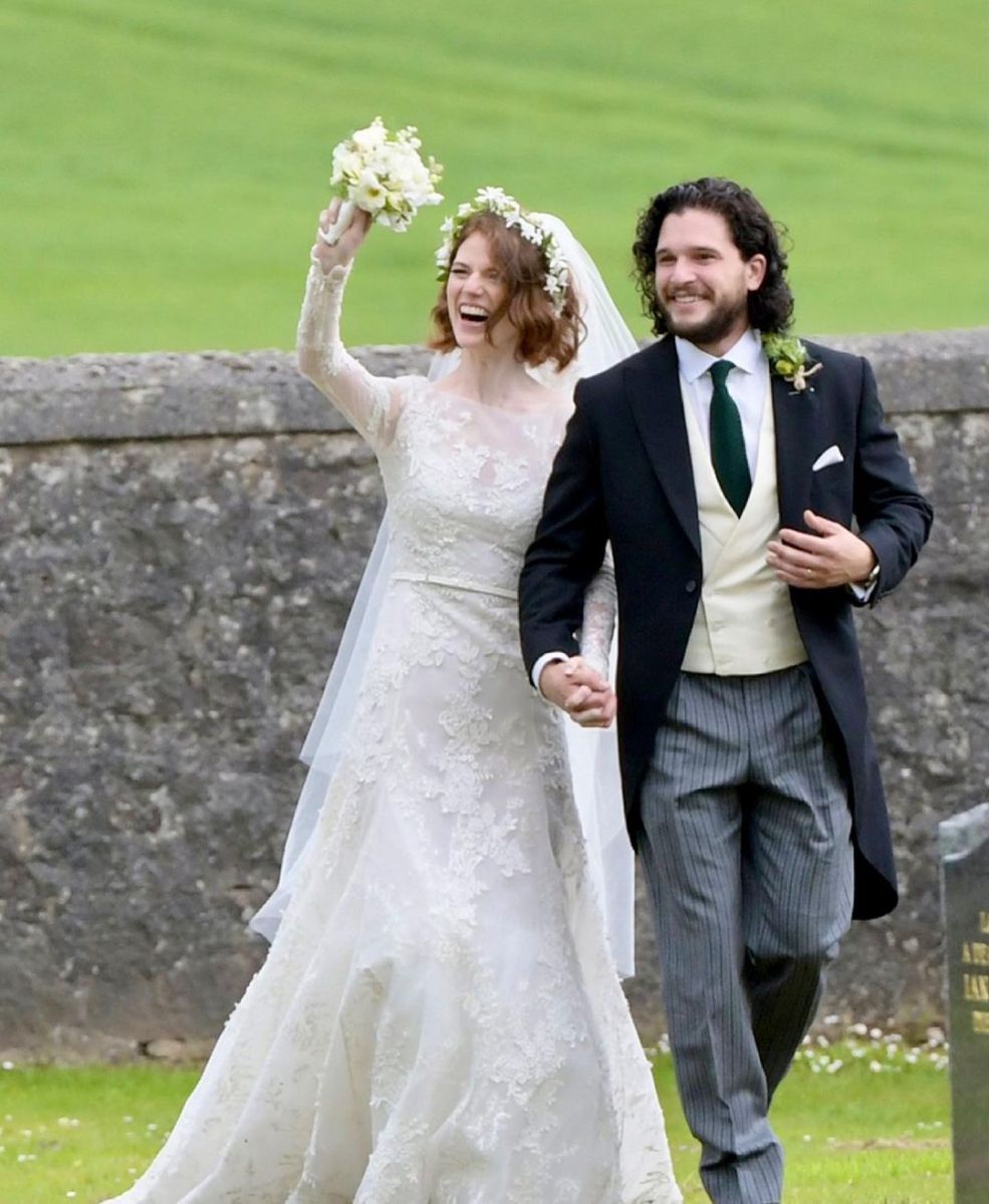 Kit Harington and Rose Leslie with big smiles at their wedding.