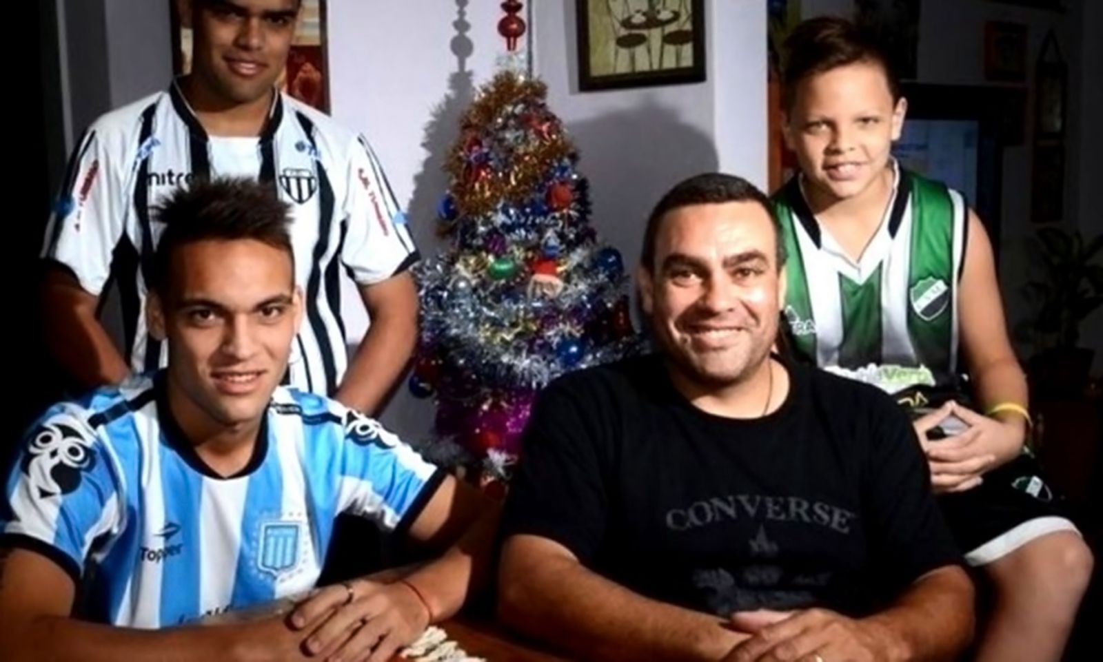 Lautaro Martinez posing with his father and brothers