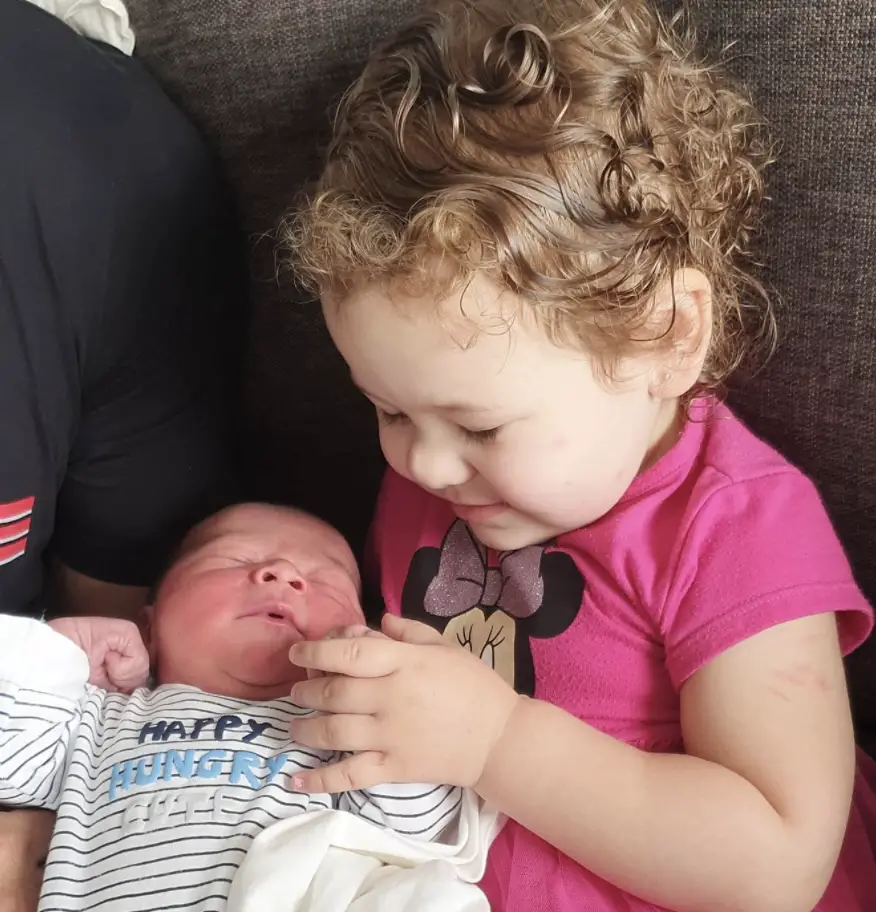 Miesha Tate and husband Johnny Nunez's daughter Amaia holding onto her little brother's hand