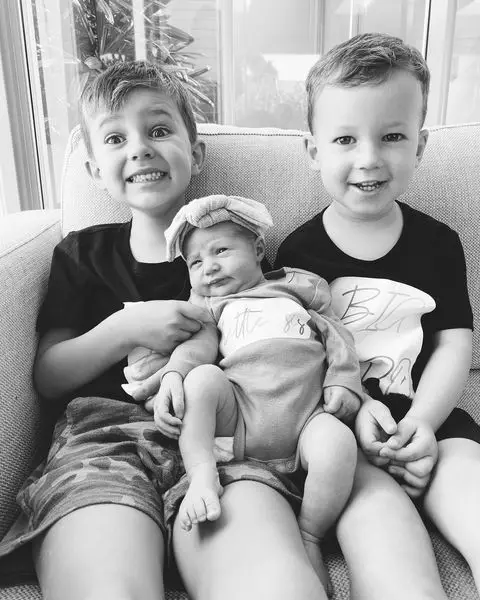Nikki Phillips's two sons looking elated after she welcomed her third child, daughter Billie Rose Rumble, in March 2022.