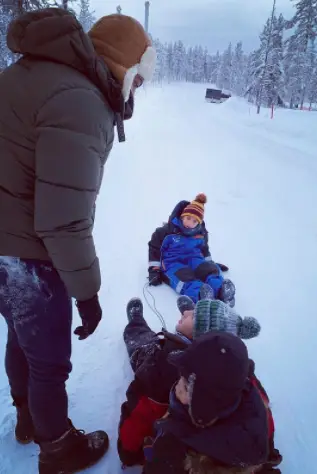 Noel Clarke and his children playing in the snow.
