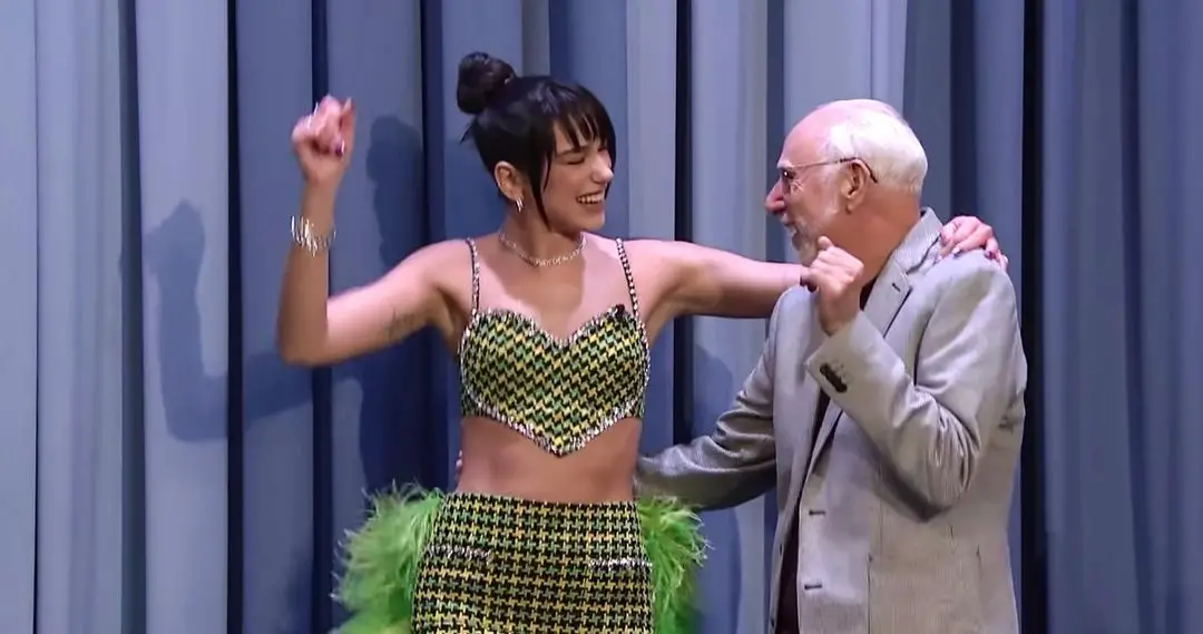 Papa Richy, a fan of Dua Lipa, dances with his favorite star. 