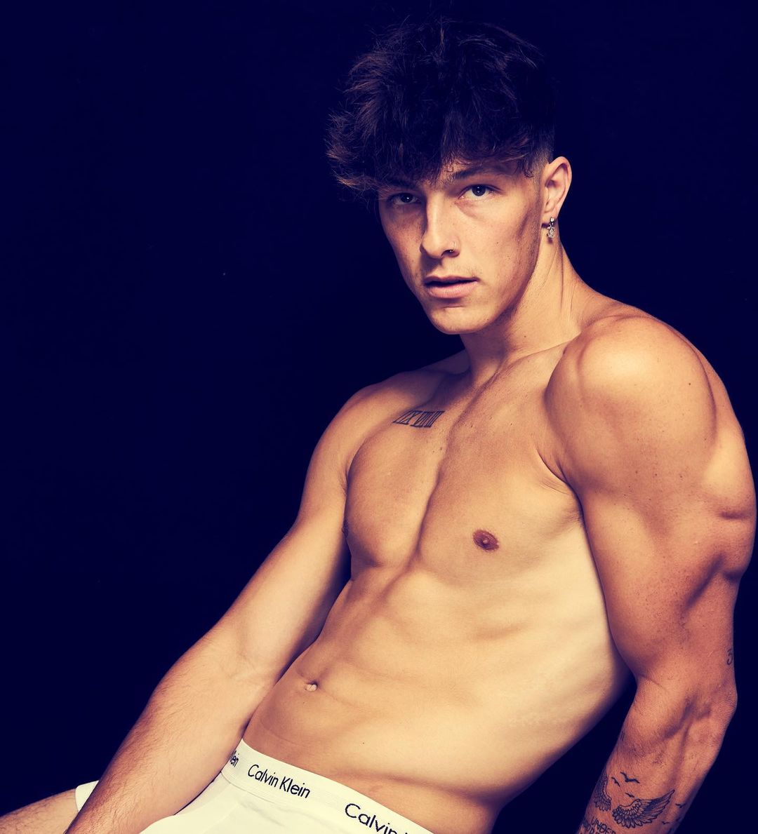 Tayler Holder posing for a picture shirtless with Calvin Klein underwear