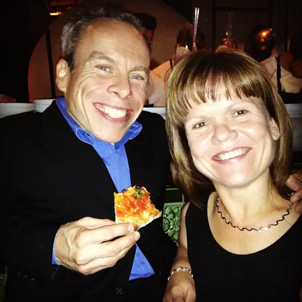 Warwick Davis posing with his wife, Sam. 
