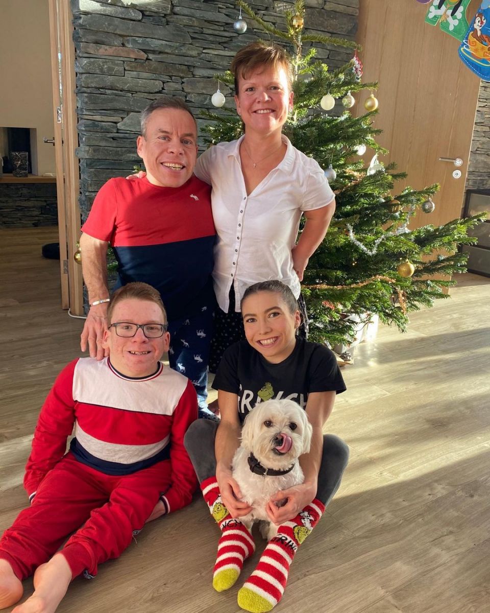 The actor posing with his wife and kids in front of a Christmas tree. 