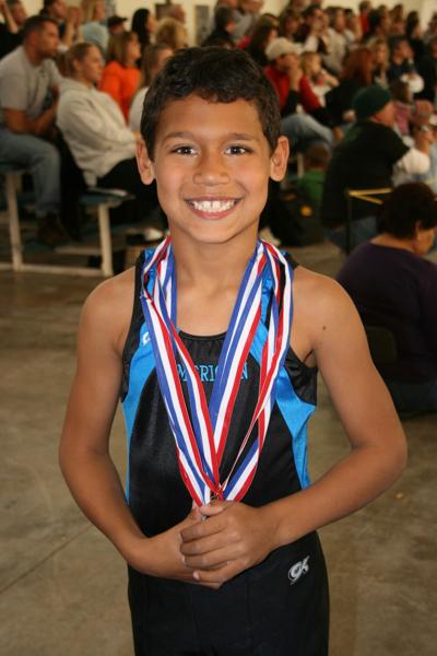 Zaven Collins shows off his gymnastic medals