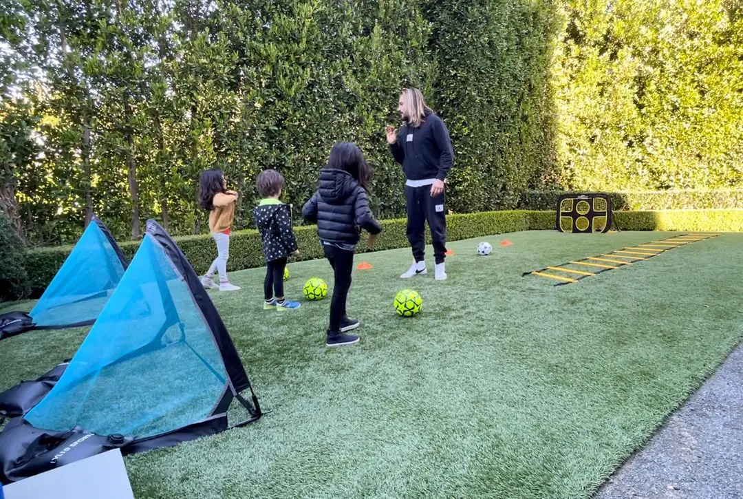 Zoe Saldana's husband playing soccer with their kids.