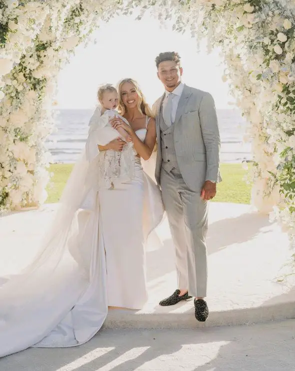 Patrick Mahomes with his wife and daughter on their wedding day.