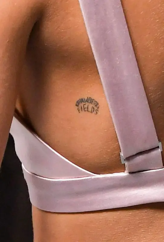 Kaia Gerber's Strawberry Fields tattoo on her left back.