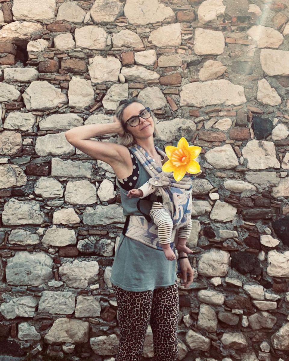 Sophia Di Martino posing for a picture with her baby son