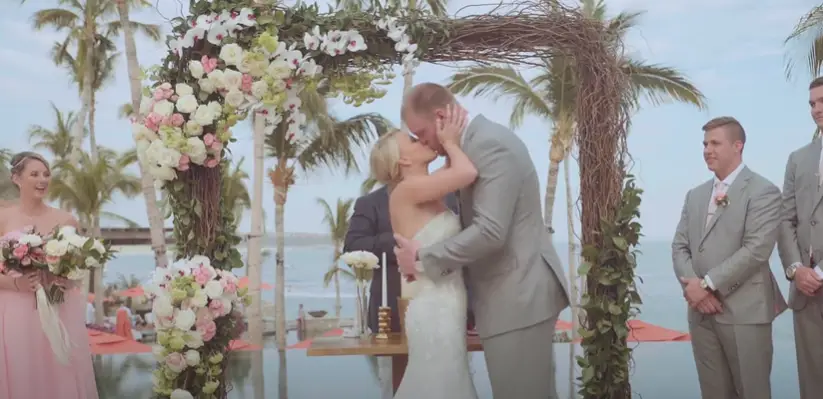 Kyle Rudolph and his wife kissing at their wedding